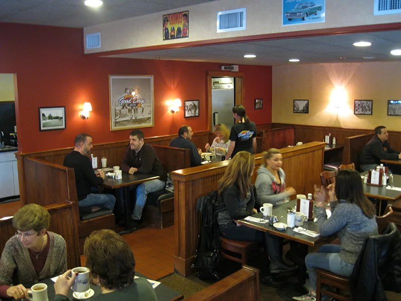 Guests having breakfast in the wooden booths