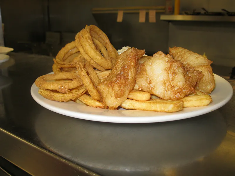 Fried haddock with onion rings and French fries