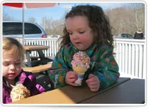 Two kids holding ice cream cones