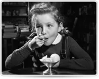 Vintage photo of a girl enjoying an ice cream sundae